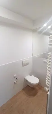 a white bathroom with a toilet in a room at Kaim Hill Cracow Chillout Zone in Kraków