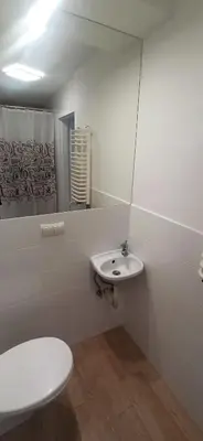 a bathroom with a white toilet and a sink at Kaim Hill Cracow Chillout Zone in Kraków