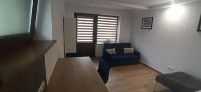 a living room with a table and a blue chair at Kaim Hill Cracow Chillout Zone in Kraków
