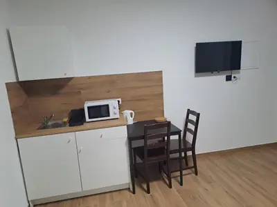 a small kitchen with a table and a microwave at Kaim Hill Cracow Chillout Zone in Kraków
