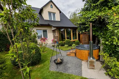 a house with a hot tub in the yard at Dom w górach z kominkiem i balią ogrodową Sielanka in Skomielna Czarna