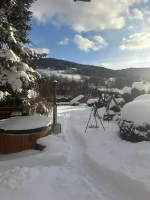 a snow covered yard with a picnic table and a table at Dom w górach z kominkiem i balią ogrodową Sielanka in Skomielna Czarna
