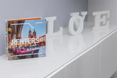 a book on a wall with a picture of big ben at Cracow Prądnik Spacious & Family Apartment with 3 bedroom by Renters Prestige in Kraków