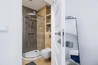 a bathroom with a shower and a toilet at Cracow Prądnik Spacious & Family Apartment with 3 bedroom by Renters Prestige in Kraków