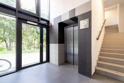 a hallway with a staircase and glass doors at Cracow Prądnik Spacious & Family Apartment with 3 bedroom by Renters Prestige in Kraków