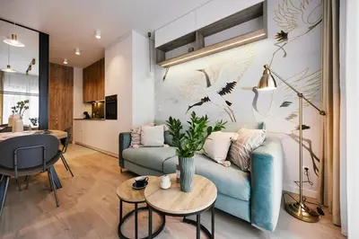 a living room with a blue couch and a table at Golden Dreams Luxury Apartments 21 in Kraków