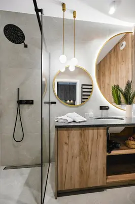 a bathroom with a shower and a sink with a mirror at Golden Dreams Luxury Apartments 21 in Kraków