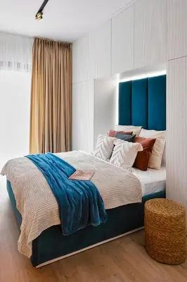 a bedroom with a large bed with a blue headboard at Golden Dreams Luxury Apartments 21 in Kraków