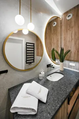 a bathroom with a sink and a mirror at Golden Dreams Luxury Apartments 21 in Kraków