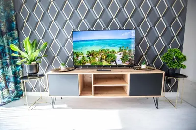 a tv sitting on top of a wooden cabinet at Wlodarska 4a Lux Premium in Kraków