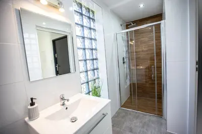 a white bathroom with a sink and a shower at Wlodarska 4a Lux Premium in Kraków