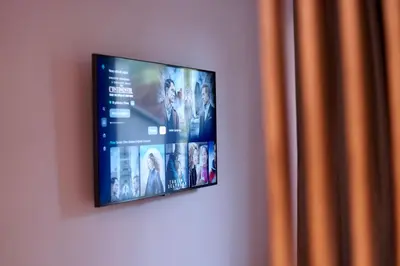 a flat screen tv hanging on a wall at Kalwa Nest Stare Podgórze in Kraków