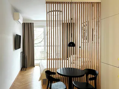 a dining room with a black table and black chairs at Kalwa Nest Stare Podgórze in Kraków