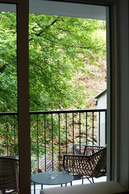 a view of a balcony with two chairs and a table at Kalwa Nest Stare Podgórze in Kraków