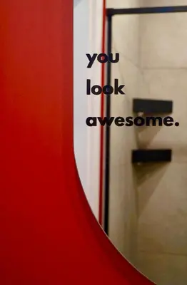 a red door with a sign that says you look awesome at Kalwa Nest Stare Podgórze in Kraków