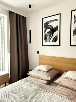 a bedroom with two beds and a window at Kalwa Nest Stare Podgórze in Kraków