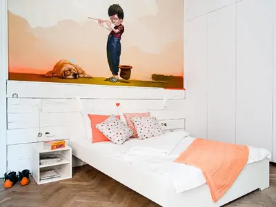 a bedroom with a bed with a painting on the wall at Boom Apartments in Kraków
