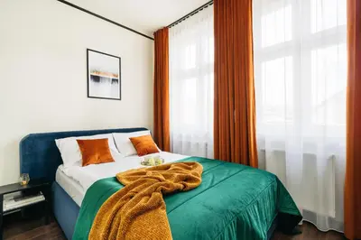 a bedroom with a bed with a blanket on it at Estery12 in Kraków