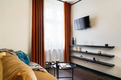 a living room with a couch and a tv at Estery12 in Kraków