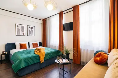 a bedroom with a bed and a couch at Estery12 in Kraków