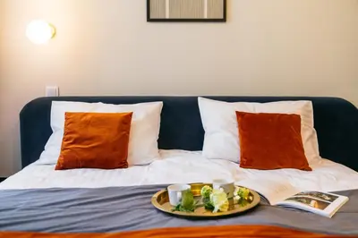 a tray of food on a bed with a plate of food at Estery12 in Kraków
