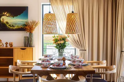 a dining room with a table with cups and plates at Lisie Sprawki in Bebło