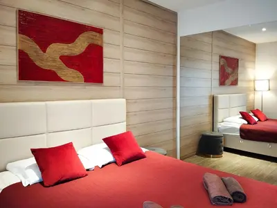 a bedroom with two beds with red pillows at Romantica SPA Kraków in Kraków