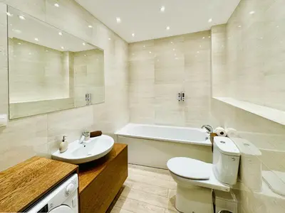 a bath tub with red lights and a bottle of wine at Romantica SPA Kraków in Kraków