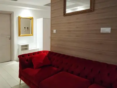 a room with a large fish tank with a bottle of wine at Romantica SPA Kraków in Kraków