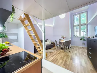 a kitchen and dining room with a staircase in a tiny apartment at Apartament przy Rynku Długa 23 in Kraków