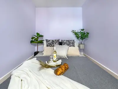 a room with a bed with a table with bread on it at Apartament przy Rynku Długa 23 in Kraków