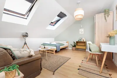 a living room with a couch and a bed at Pastel Grove Suite - by Upstairs in Kraków