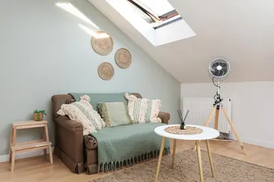 a living room with a couch and a table at Pastel Grove Suite - by Upstairs in Kraków