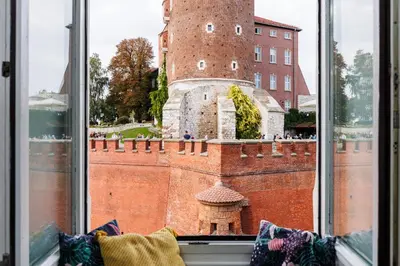 a window with a view of a castle at Wawel Castle View - City Center Suite - by Upstairs in Kraków