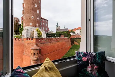 a window with a view of a castle at Wawel Castle View - City Center Suite - by Upstairs in Kraków