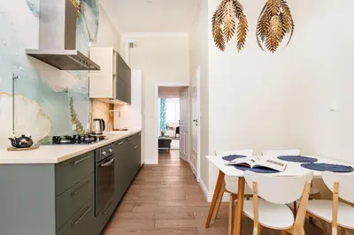 a kitchen with a table and chairs in a room at Wawel Castle View - City Center Suite - by Upstairs in Kraków