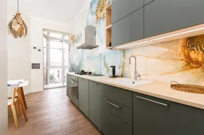 a kitchen with green cabinets and a sink at Wawel Castle View - City Center Suite - by Upstairs in Kraków