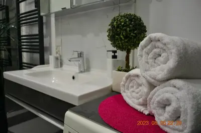 a bathroom with a sink and towels on a counter at Apartment near Old Town in Kraków