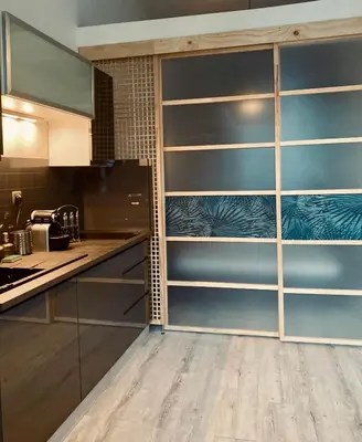a kitchen with wooden shelves in a kitchen at Apartment near Old Town in Kraków