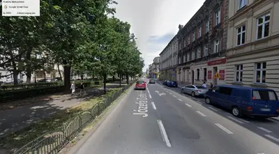 a city street with cars parked on the side of the road at Apartment near Old Town in Kraków