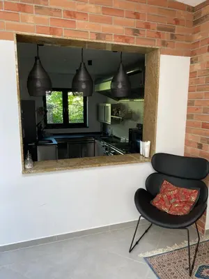 a black chair in a kitchen with a mirror at Stara Plebania in Ponice