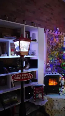 a living room with a fireplace and a christmas tree at Stara Plebania in Ponice