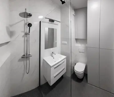 a white bathroom with a sink and a toilet at Like Home Apartments in Kraków