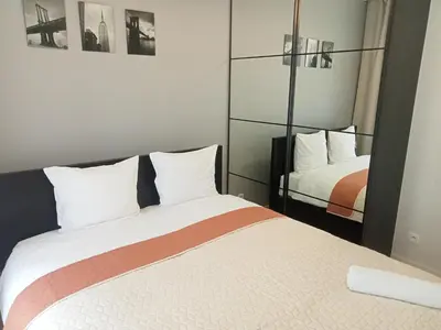a hotel room with a bed and a mirror at Like Home Apartments in Kraków
