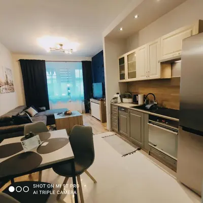 a small living room with a couch and a table at Seventh House in Kraków