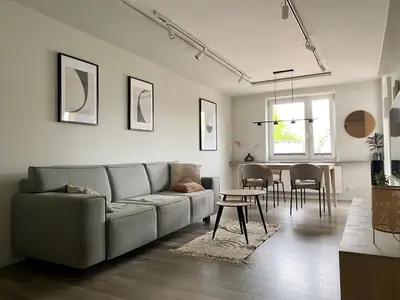 a living room with a couch and a table at Z widokiem na Wisłę in Kraków