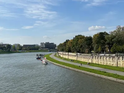 a river with two boats in the water at Z widokiem na Wisłę in Kraków