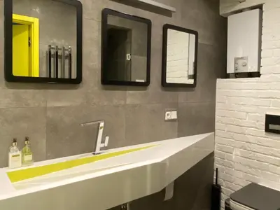 a bathroom with a white sink and two mirrors at Z widokiem na Wisłę in Kraków