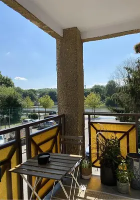 a patio with a table and a view of the water at Z widokiem na Wisłę in Kraków