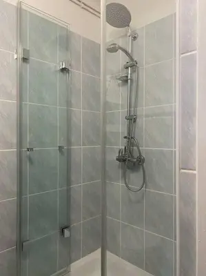 a bathroom with a shower with a glass door at Apartament na starej Krowodrzy in Kraków